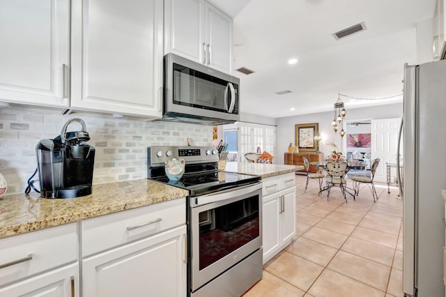 2971 SE Morningside Blvd, Port Saint Lucie, FL 34952 - kitchen featuring light tile patterned flooring, stainless steel appliances, white cabinetry, decorative backsplash, and visible vents