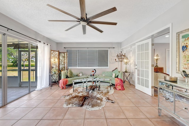 2971 SE Morningside Blvd, Port Saint Lucie, FL 34952 - living area featuring a ceiling fan, light tile patterned flooring, french doors, and a textured ceiling