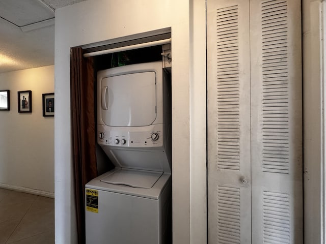 1101 Summit Place B Cir Unit B, West Palm Beach, FL 33415 - washroom featuring stacked washer / dryer, tile patterned flooring, and baseboards