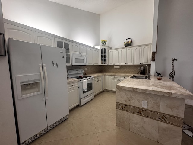 1101 Summit Place B Cir Unit B, West Palm Beach, FL 33415 - kitchen featuring white appliances, a sink, a peninsula, glass insert cabinets, and decorative backsplash