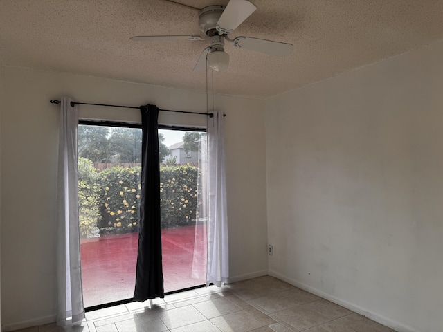 1101 Summit Place B Cir Unit B, West Palm Beach, FL 33415 - empty room with ceiling fan, a textured ceiling, light tile patterned floors, and baseboards