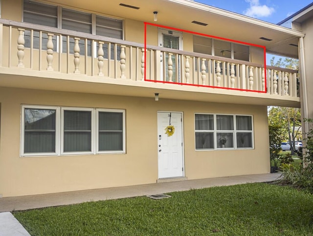 216 Sheffield I Unit 216, West Palm Beach, FL 33417 - view of front facade with a balcony and stucco siding