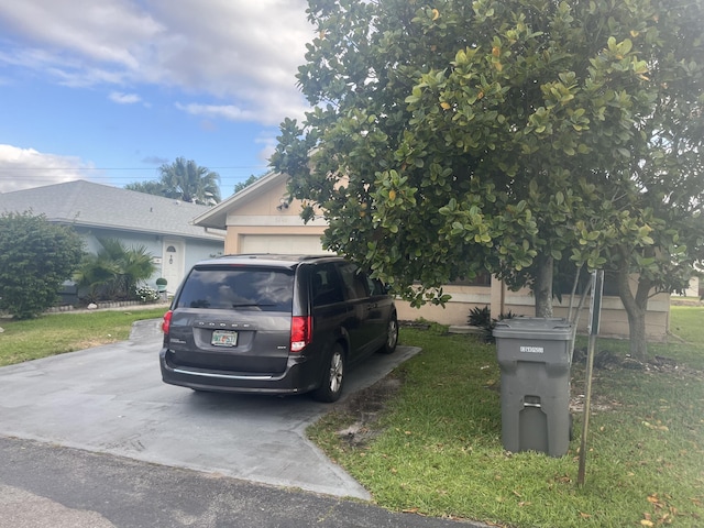 5240 Kim Ct, West Palm Beach, FL 33414 - view of property hidden behind natural elements featuring a front yard
