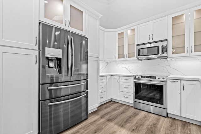 9676 Boca Gardens Pkwy Unit C, Boca Raton, FL 33496 - kitchen featuring stainless steel appliances, white cabinets, light wood-style flooring, glass insert cabinets, and light stone countertops