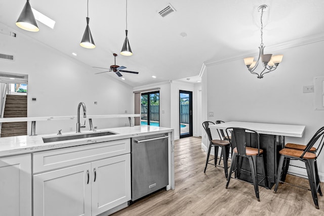 9676 Boca Gardens Pkwy Unit C, Boca Raton, FL 33496 - kitchen featuring stainless steel dishwasher, crown molding, white cabinets, light wood-type flooring, and light stone countertops