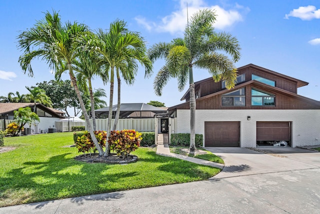 9676 Boca Gardens Pkwy Unit C, Boca Raton, FL 33496 - view of front facade with concrete driveway, a front yard, a garage, and brick siding