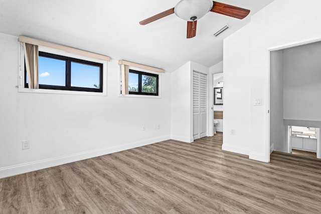 9676 Boca Gardens Pkwy Unit C, Boca Raton, FL 33496 - unfurnished bedroom with wood finished floors, connected bathroom, lofted ceiling, and ceiling fan