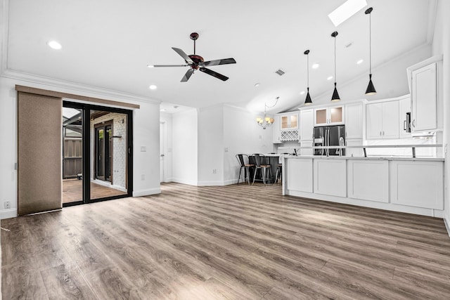9676 Boca Gardens Pkwy Unit C, Boca Raton, FL 33496 - unfurnished living room featuring recessed lighting, ornamental molding, a ceiling fan, wood finished floors, and lofted ceiling