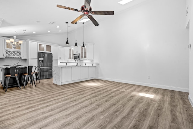 9676 Boca Gardens Pkwy Unit C, Boca Raton, FL 33496 - living room featuring ornamental molding, light wood finished floors, a chandelier, a ceiling fan, and vaulted ceiling