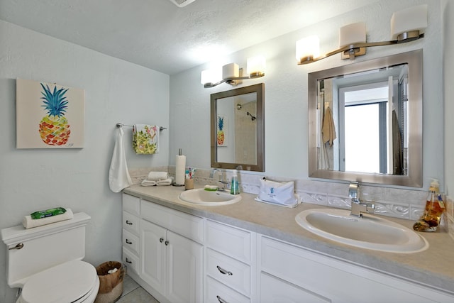 full bath with double vanity, a sink, and toilet