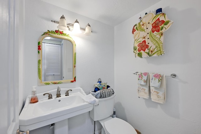 half bathroom with a sink and toilet