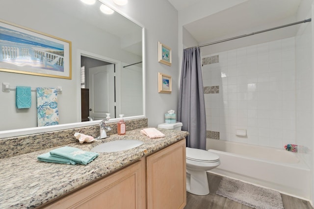 bathroom with toilet, wood finished floors, shower / tub combo with curtain, and vanity
