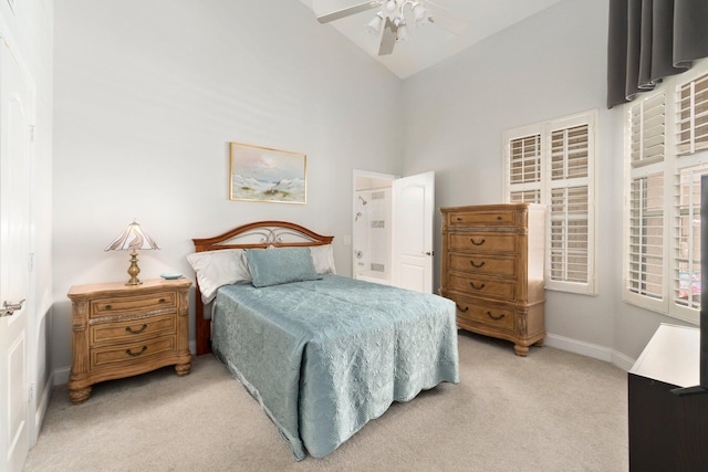 bedroom featuring baseboards, a ceiling fan, high vaulted ceiling, and light colored carpet