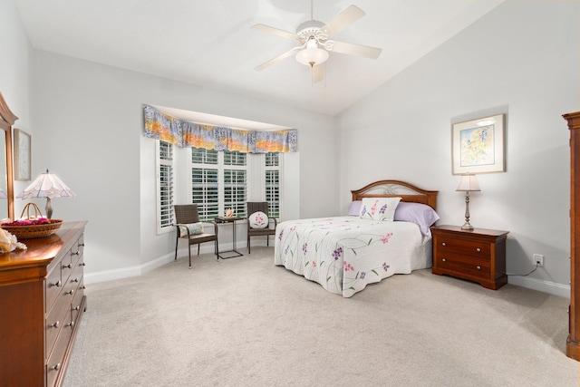 bedroom with baseboards, ceiling fan, light carpet, and lofted ceiling