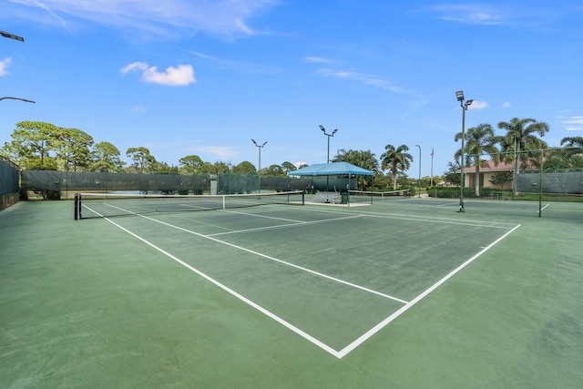 view of sport court featuring fence