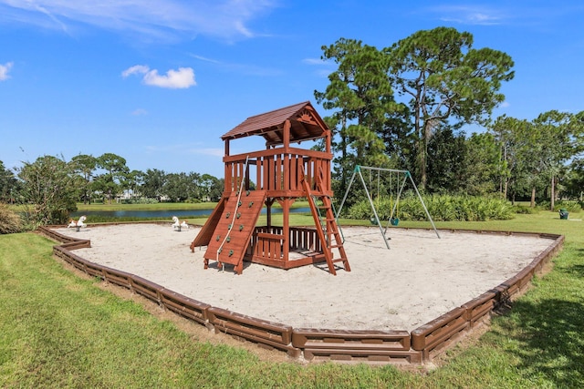 communal playground featuring a water view and a yard