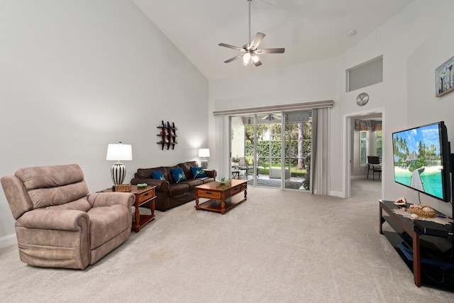 living room featuring baseboards, carpet flooring, a ceiling fan, and high vaulted ceiling