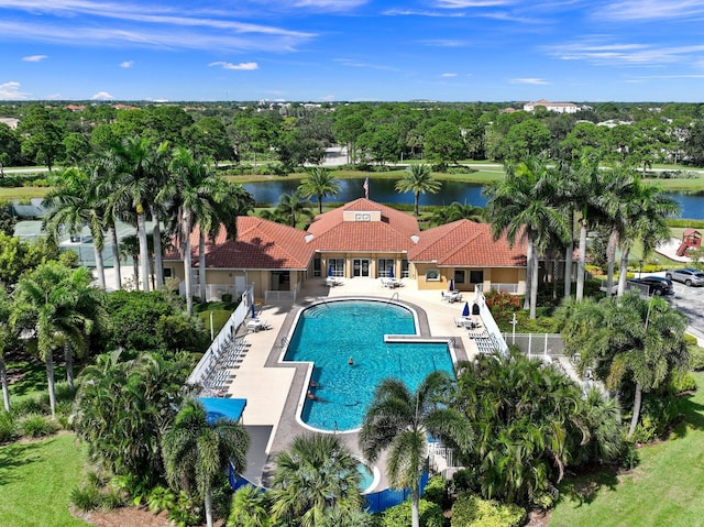 pool featuring a patio and a water view