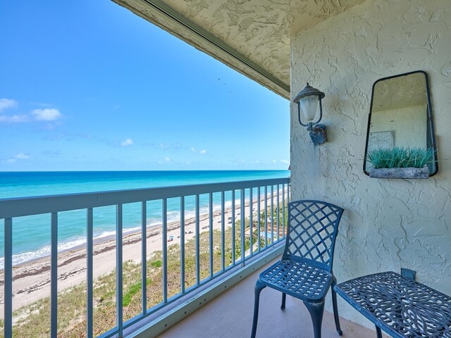 balcony with a beach view and a water view
