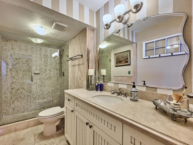 bathroom featuring vanity, toilet, and a shower stall