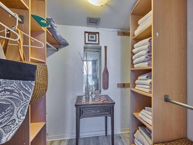 walk in closet featuring wood finished floors and visible vents