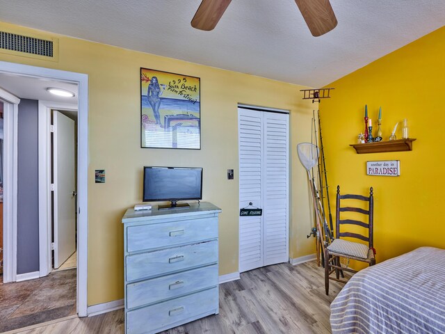 bedroom with a closet, baseboards, visible vents, and light wood-style floors