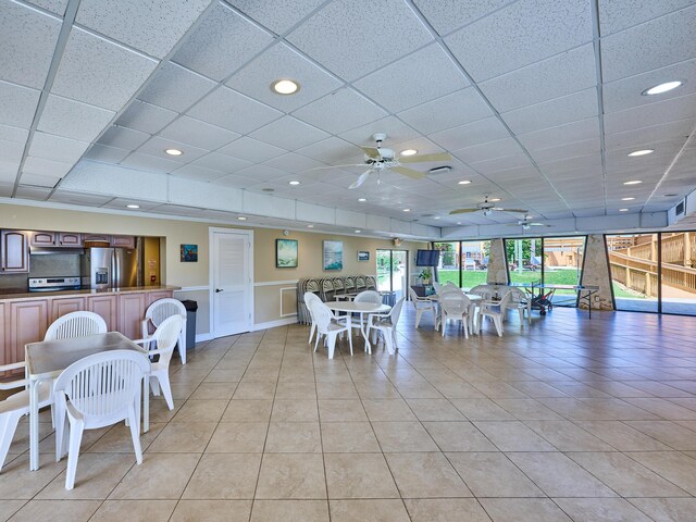 dining area featuring recessed lighting, a ceiling fan, a wainscoted wall, and light tile patterned flooring