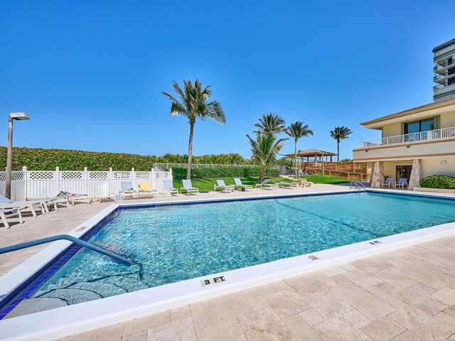 community pool featuring a patio and fence