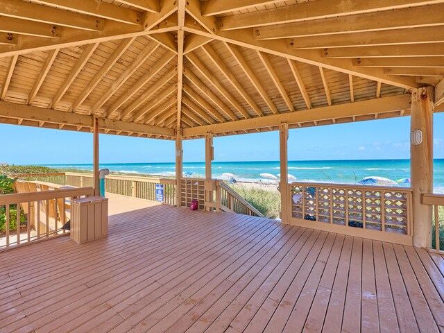 deck with a water view and a view of the beach