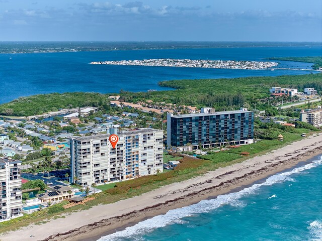 bird's eye view featuring a water view and a beach view