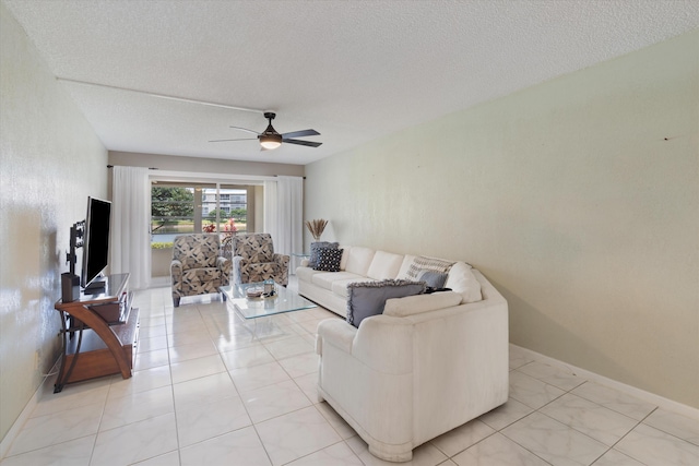 living room with baseboards, a textured ceiling, and ceiling fan