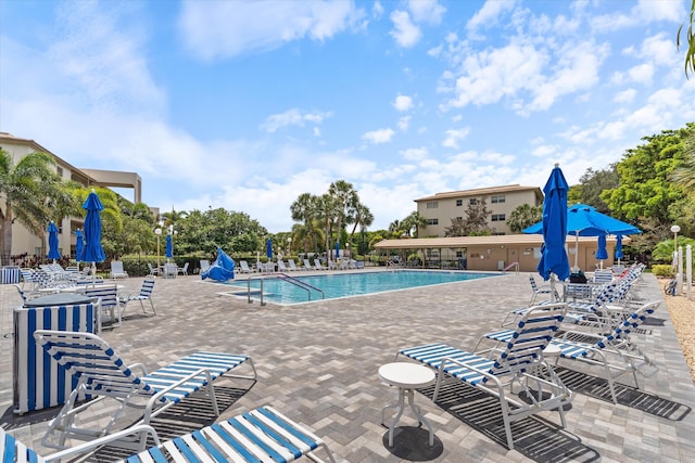 pool featuring a patio and fence