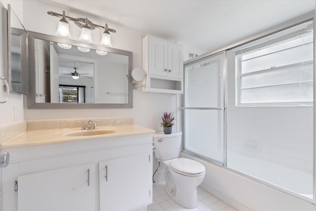 bathroom with vanity, tile patterned floors, toilet, and a wealth of natural light