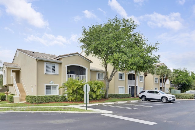248 Village Blvd Unit 3203, Tequesta, FL 33469 - view of building exterior featuring uncovered parking and stairway