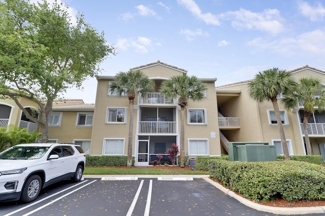 248 Village Blvd Unit 3203, Tequesta, FL 33469 - view of building exterior featuring central air condition unit and uncovered parking