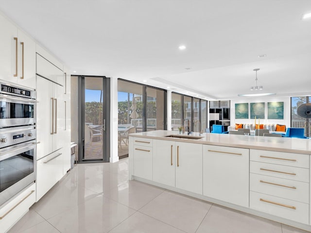 3300 S Ocean Blvd Unit 108S, Palm Beach, FL 33480 - kitchen featuring modern cabinets, light countertops, white cabinets, a sink, and light tile patterned floors