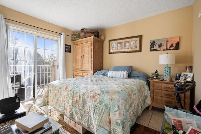 1627 SE Green Acres Cir Unit Z-203, Port Saint Lucie, FL 34952 - bedroom with tile patterned floors, a textured ceiling, and access to exterior