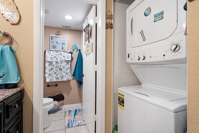 1627 SE Green Acres Cir Unit Z-203, Port Saint Lucie, FL 34952 - clothes washing area featuring light tile patterned floors, laundry area, visible vents, and stacked washer / dryer