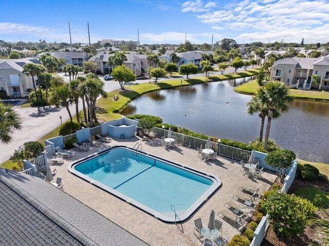 1627 SE Green Acres Cir Unit Z-203, Port Saint Lucie, FL 34952 - pool with fence, a water view, a patio area, and a residential view