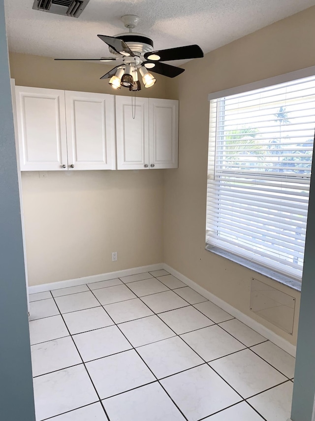 1120 Mahogany Way Unit 203, Delray Beach, FL 33445 - empty room featuring ceiling fan, light tile patterned flooring, baseboards, and a textured ceiling