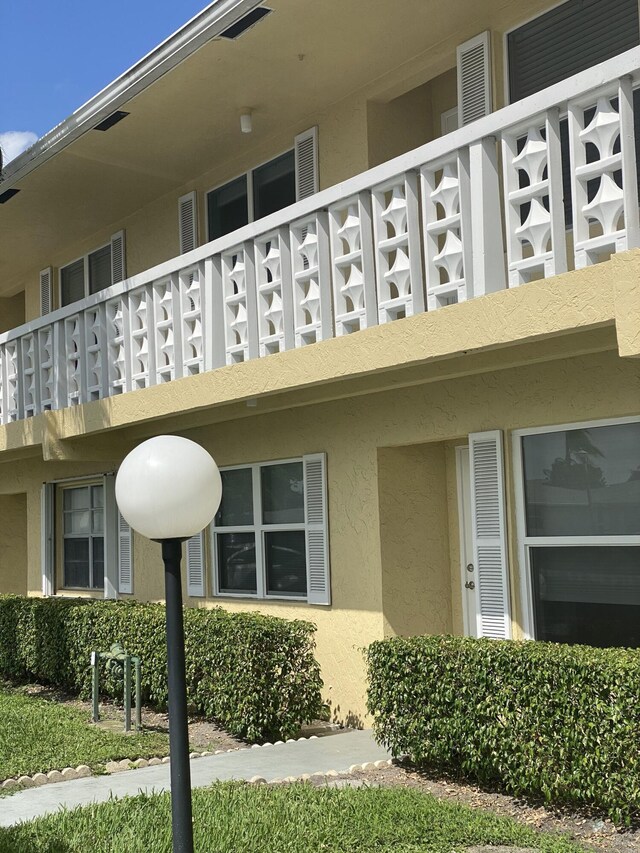 1120 Mahogany Way Unit 203, Delray Beach, FL 33445 - view of side of property with stucco siding and a balcony
