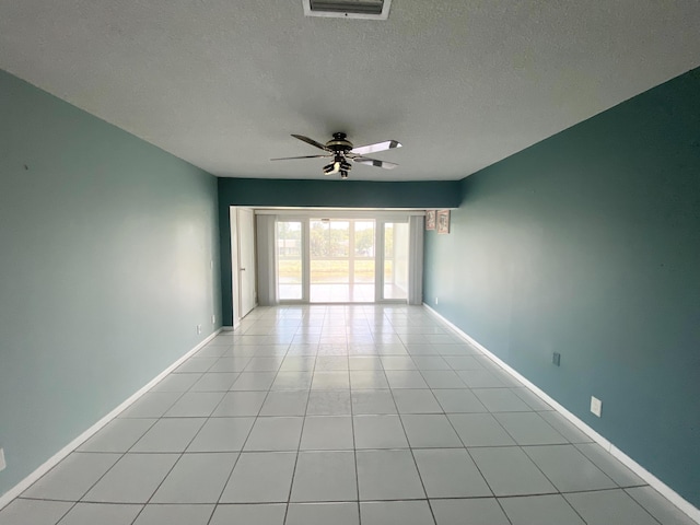 1120 Mahogany Way Unit 203, Delray Beach, FL 33445 - unfurnished room featuring a ceiling fan, light tile patterned flooring, a textured ceiling, and baseboards