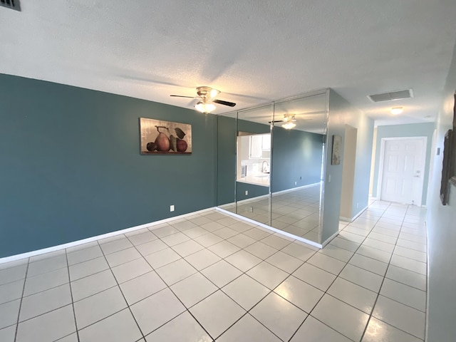 1120 Mahogany Way Unit 203, Delray Beach, FL 33445 - spare room with light tile patterned floors, ceiling fan, a textured ceiling, and baseboards
