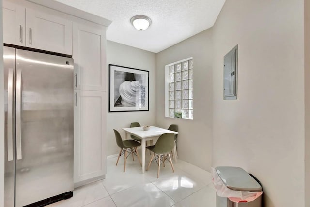 5438 Verona Dr Unit H, Boynton Beach, FL 33437 - dining space with electric panel, light tile patterned floors, baseboards, and a textured ceiling