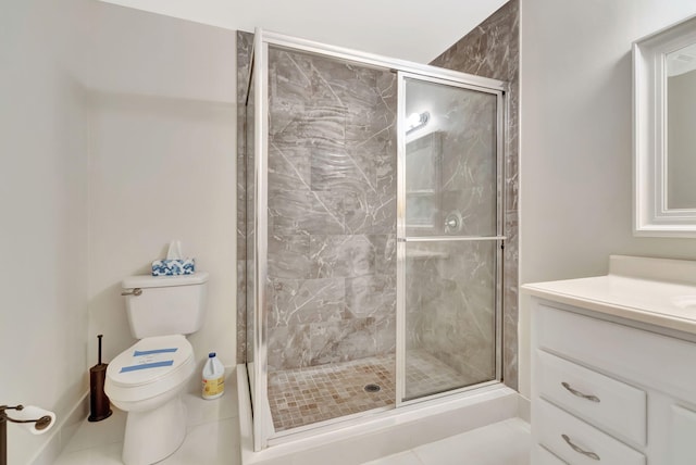bathroom featuring vanity, tile patterned flooring, a shower stall, and toilet