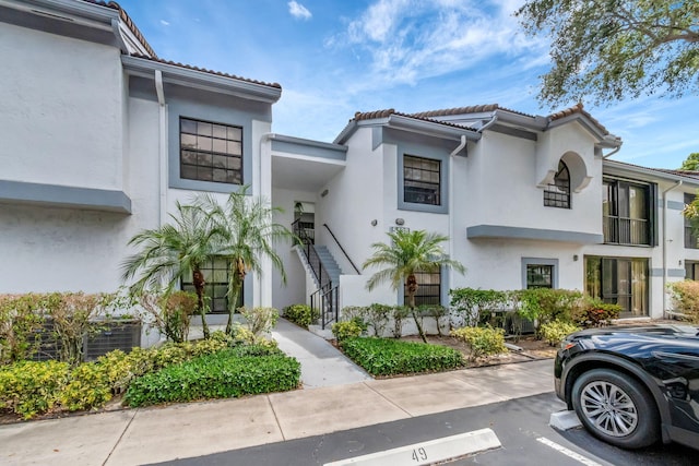 5438 Verona Dr Unit H, Boynton Beach, FL 33437 - multi unit property featuring stucco siding, uncovered parking, a tiled roof, and stairway