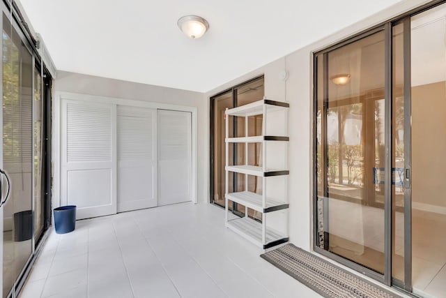 interior space with tile patterned flooring and a closet