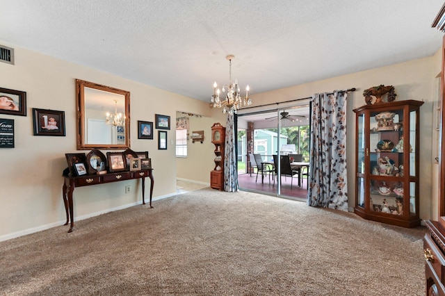 2104 S 26th St, Fort Pierce, FL 34947 - dining space with a chandelier, carpet, healthy amount of natural light, baseboards, and a textured ceiling