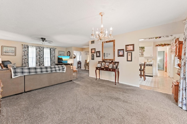 2104 S 26th St, Fort Pierce, FL 34947 - living room featuring a chandelier, carpet floors, a ceiling fan, and baseboards