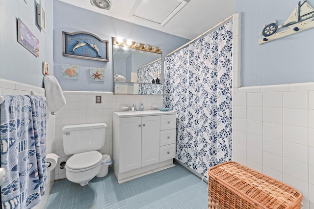 2104 S 26th St, Fort Pierce, FL 34947 - bathroom featuring tile walls, tile patterned flooring, toilet, a wainscoted wall, and vanity